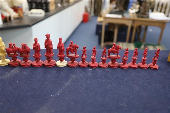 An early 19th century Chinese red stained and natural ivory rosette type chess set, kings 3.25in.